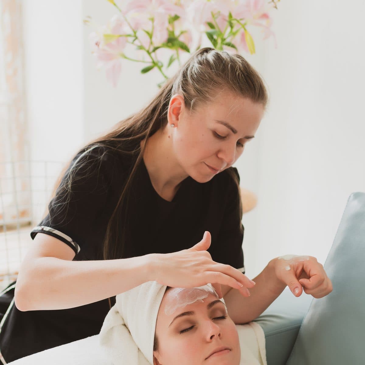 Esteticista aplicando tratamento facial em uma cliente